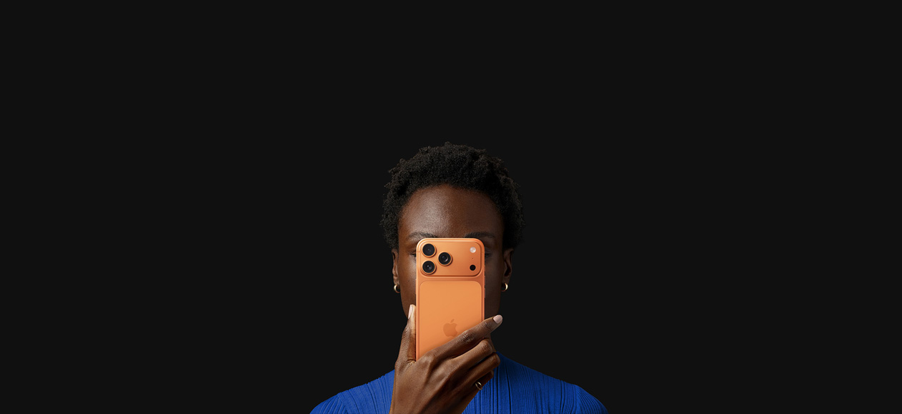 一個人將宇宙橙色 iPhone 17 Pro 舉在臉前，機背朝外